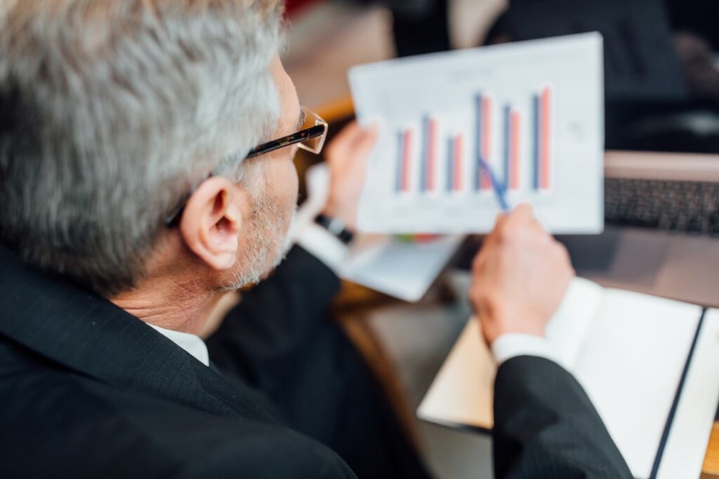 close up photo senior man sitting modern cafe shop during lunch time reading diagram